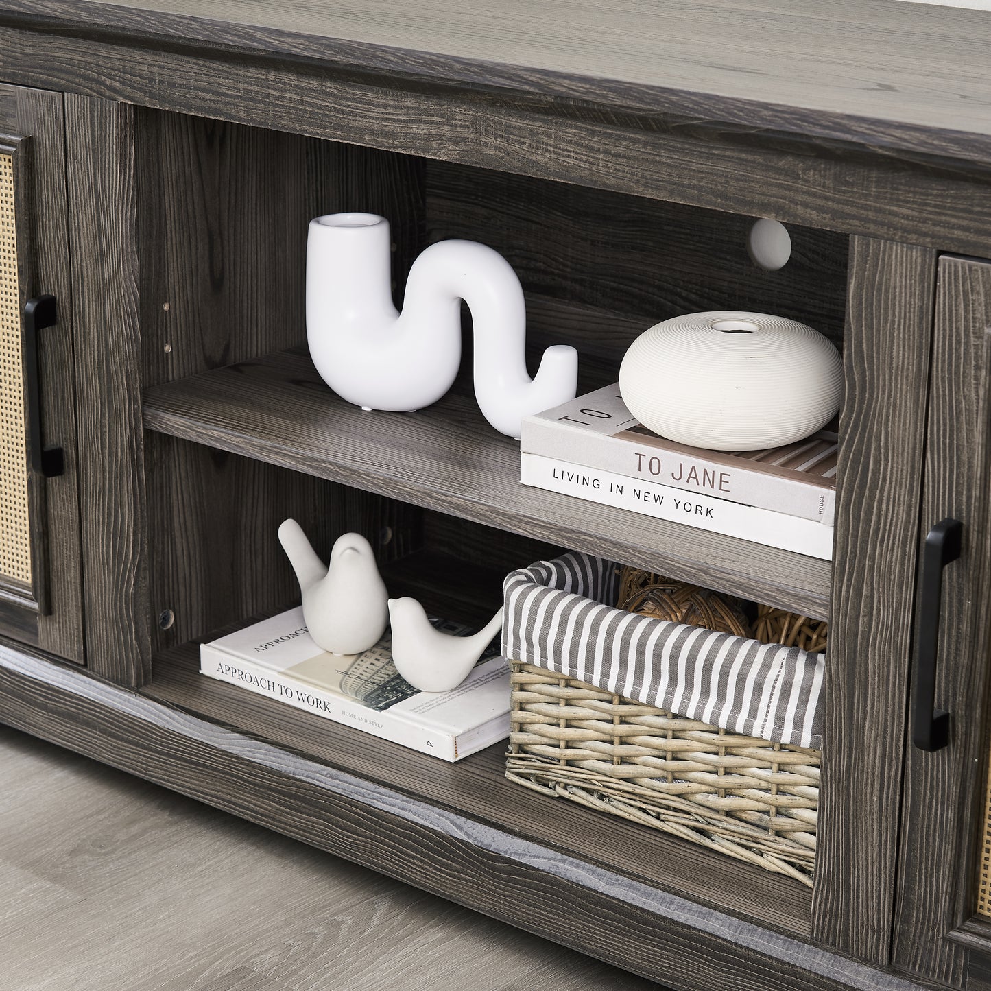 Gray TV stand with rattan doors and shelves for storage
