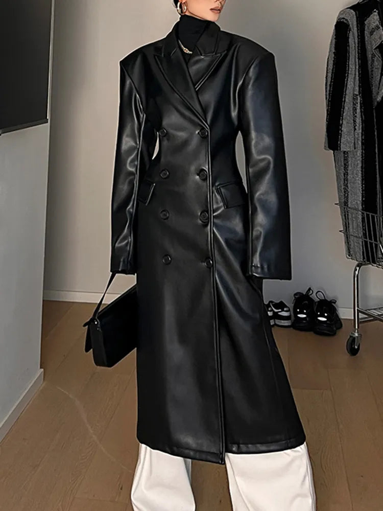 Model wearing a high-waist PU leather coat with patchwork detail and lapel collar