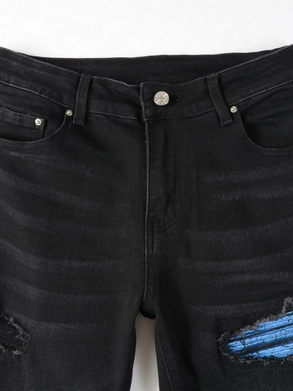 Men’s distressed skinny jeans in stretch denim with ripped detailing.

