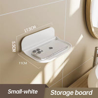Wall-mounted plastic floating shelf in a modern bathroom holding towels
