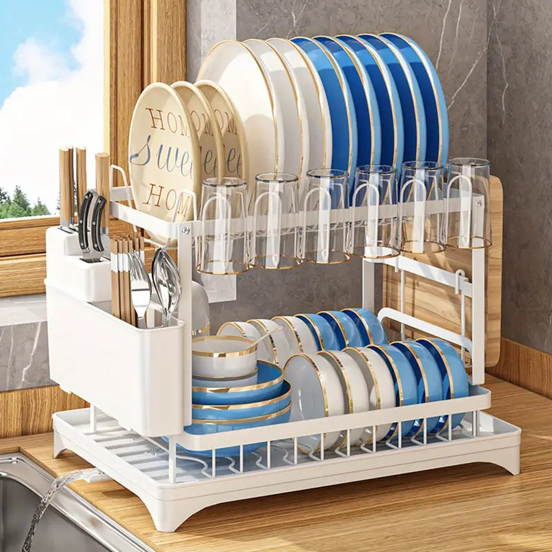 Kitchen drainage rack with bowls, plates, and utensils drying on a countertop

