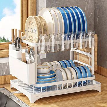 Kitchen drainage rack with bowls, plates, and utensils drying on a countertop

