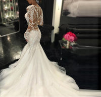 A trailing white lace wedding dress with a slim fit and elegant design, featuring intricate lace details for a timeless bridal look.

