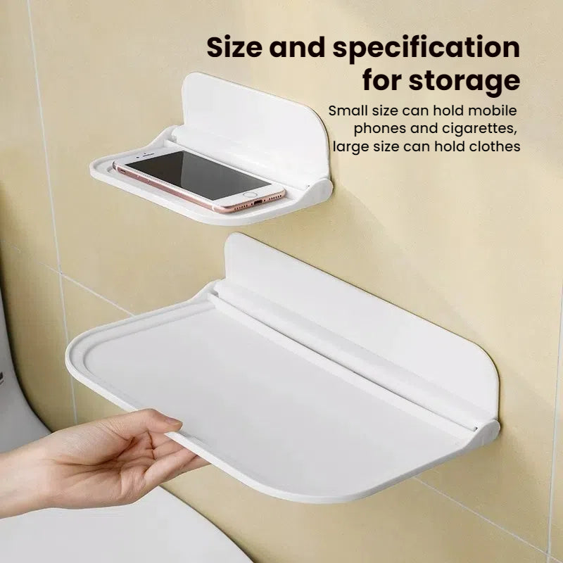 Wall-mounted plastic floating shelf in a modern bathroom holding towels