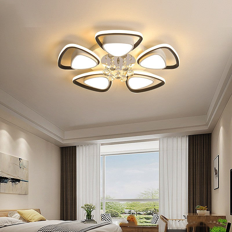 High-end modern ceiling light illuminating a cozy bedroom with elegant decor

