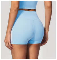 Light blue athletic shorts worn by a person on a plain background