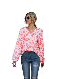 Women's long-sleeve V-neck top with a bold leopard print pattern, perfect for adding a touch of fierce fashion to your wardrobe.








