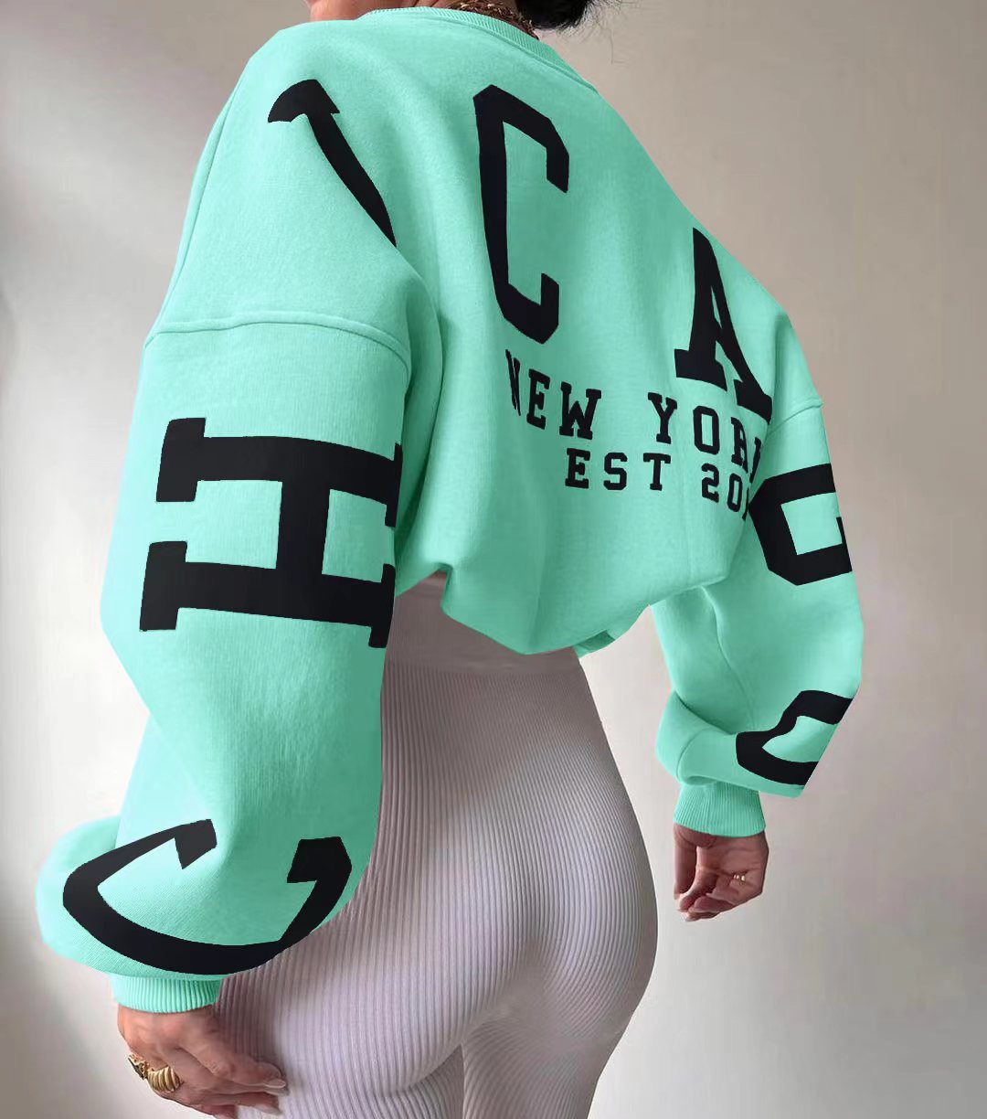 Woman wearing a printed thick long sleeve hoodie, looking cozy and stylish.

