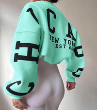 Woman wearing a printed thick long sleeve hoodie, looking cozy and stylish.

