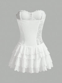 White corset-style mini dress with lace trim, structured bust, and tiered ruffled skirt on a plain gray background.