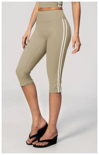 Beige capri leggings with white stripes worn by a person on a light gray background