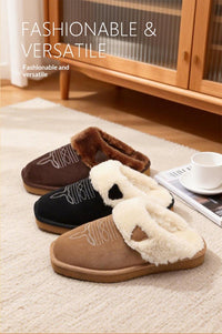 Three pairs of slip-on fleece-lined slippers in brown, black, and tan are arranged on a light rug in a home setting, with a wooden cabinet, magazine, and white cup visible in the background. Text at the top reads 'FASHIONABLE & VERSATILE'.
