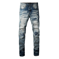 Men's slim-fit ripped jeans with distinctive patch detailing and cotton denim