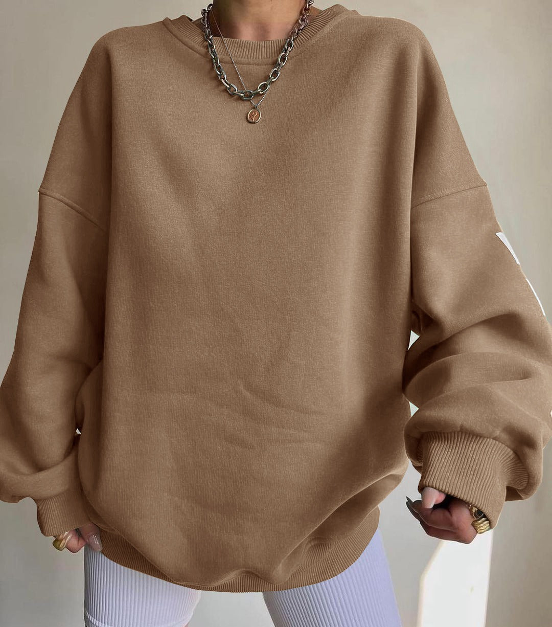 Woman wearing a printed thick long sleeve hoodie, looking cozy and stylish.

