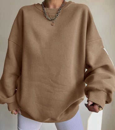 Woman wearing a printed thick long sleeve hoodie, looking cozy and stylish.

