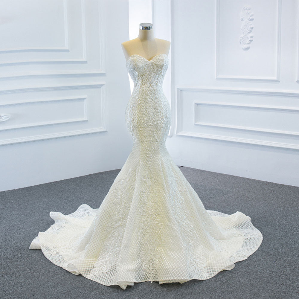 Elegant strapless tube top wedding dress with a fishtail silhouette, detachable flowing train, and intricate lace details for a dreamy bridal look.


