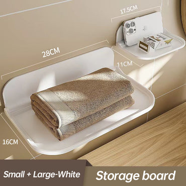 Wall-mounted plastic floating shelf in a modern bathroom holding towels