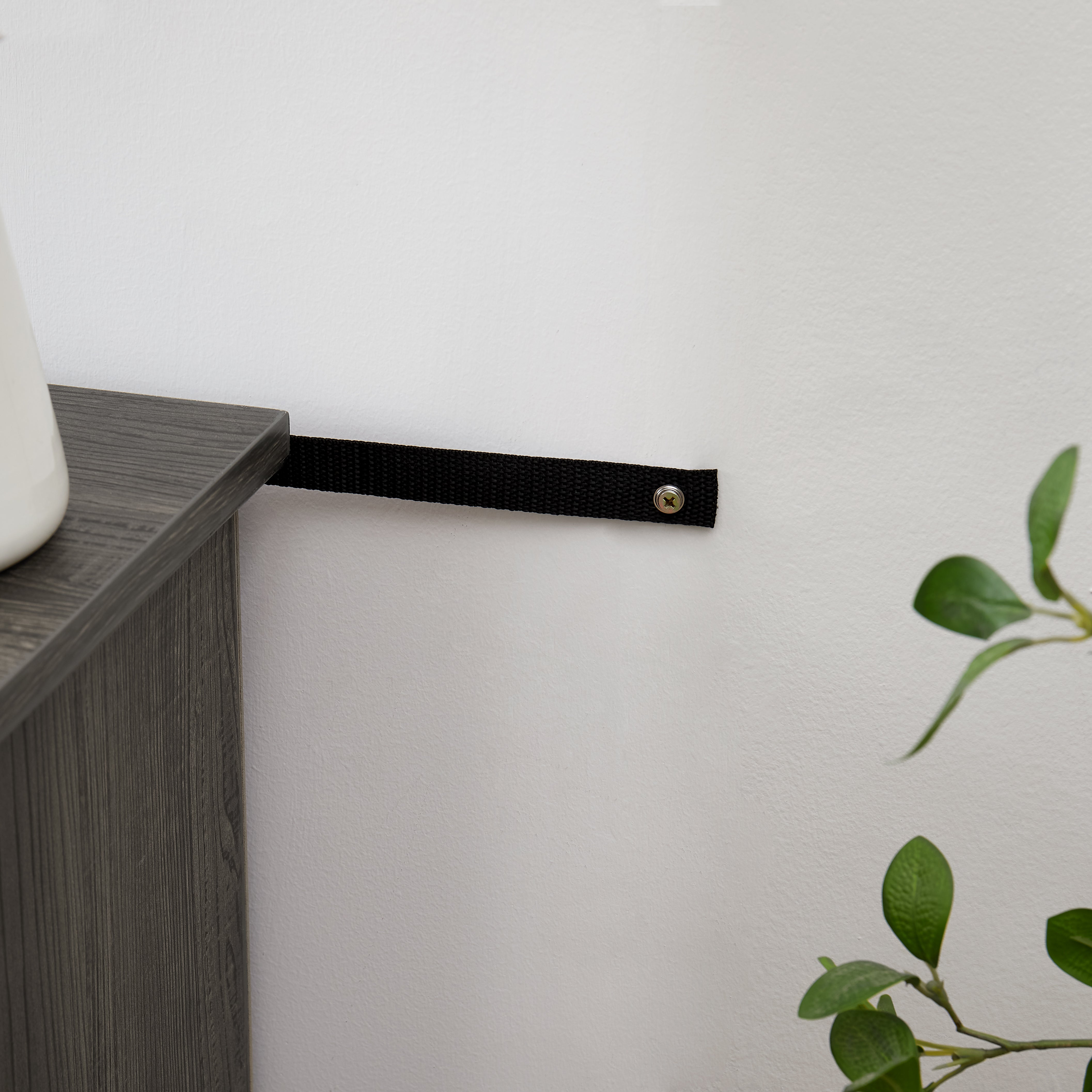 Modern gray stone TV console with open shelves and stacked stone frame