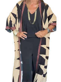Model wearing printed long cardigan with jeans and boots

