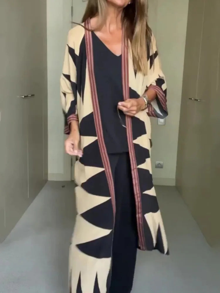 Model wearing printed long cardigan with jeans and boots

