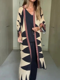 Model wearing printed long cardigan with jeans and boots


