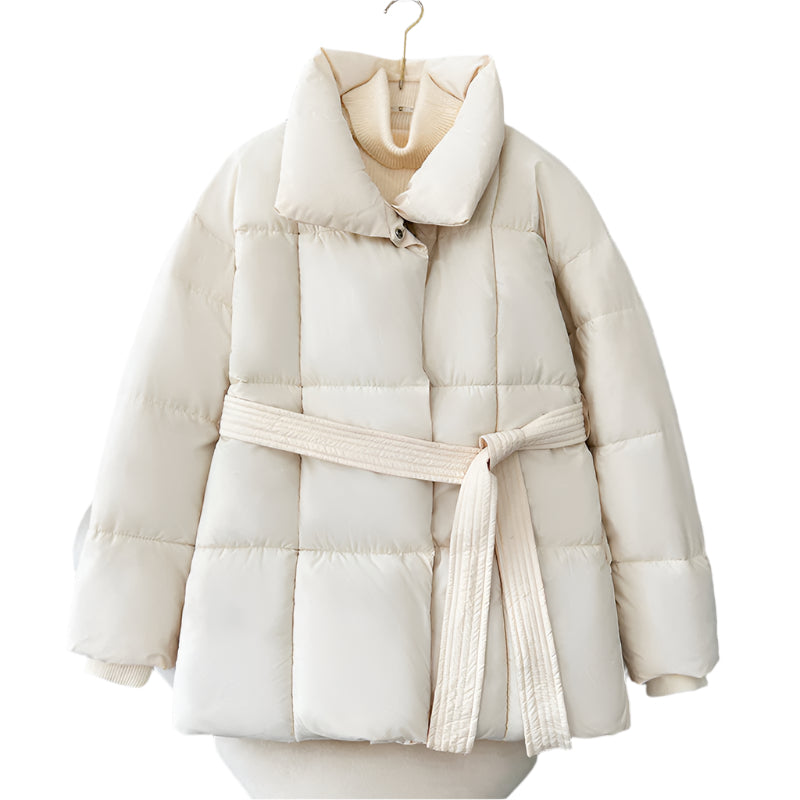 Model wearing a short tie-waist puffer jacket with a stand collar and boots