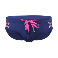 Men’s close-fitting swim briefs with polka dot stitching, designed for beach and sports activities.

