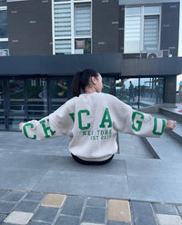Woman wearing a printed thick long sleeve hoodie, looking cozy and stylish.

