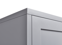 Grey metal kitchen storage cabinet with door and adjustable shelf in a modern kitchen