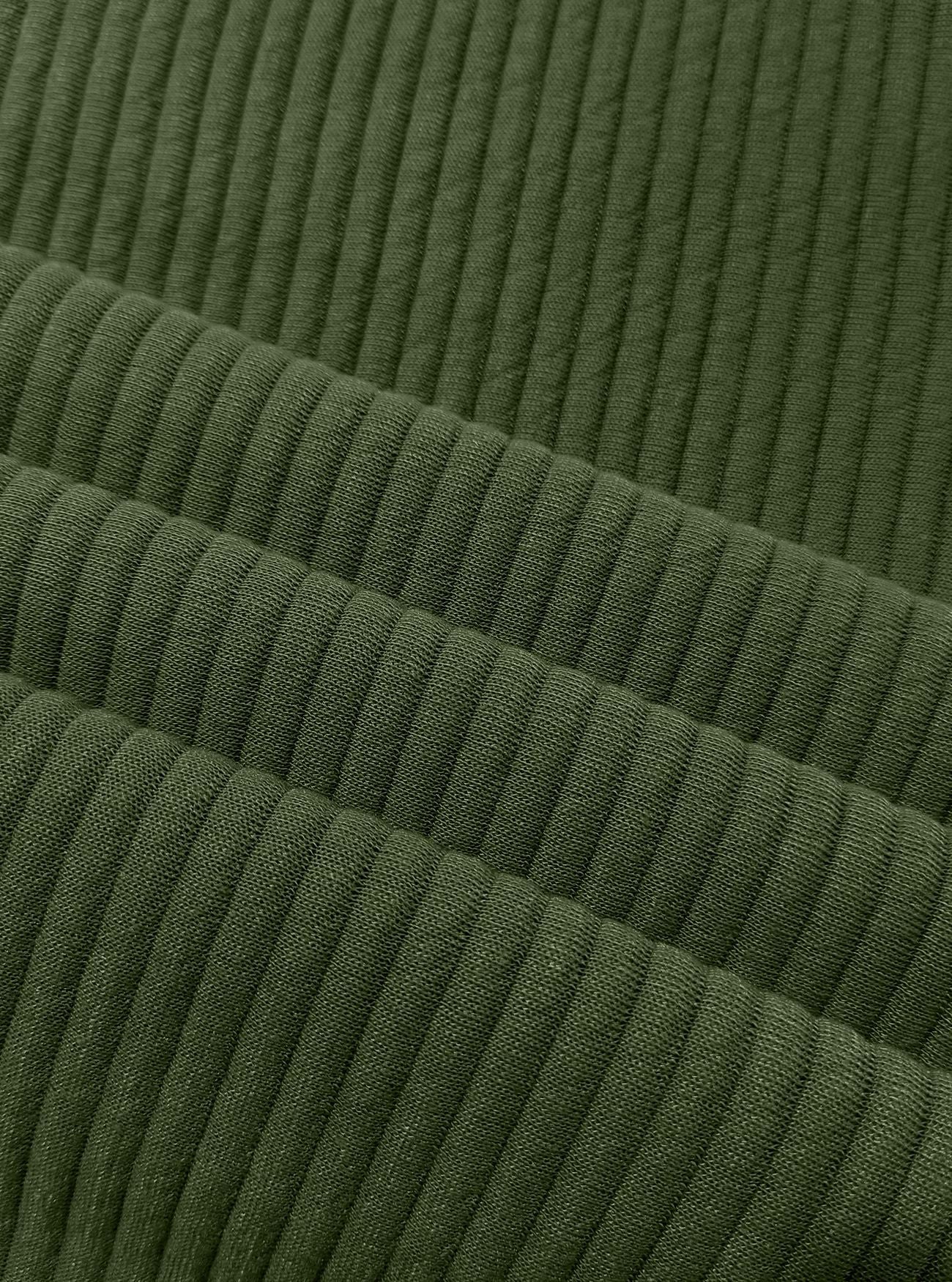 Close-up of olive green ribbed fabric with a textured corduroy-like vertical stripe pattern.