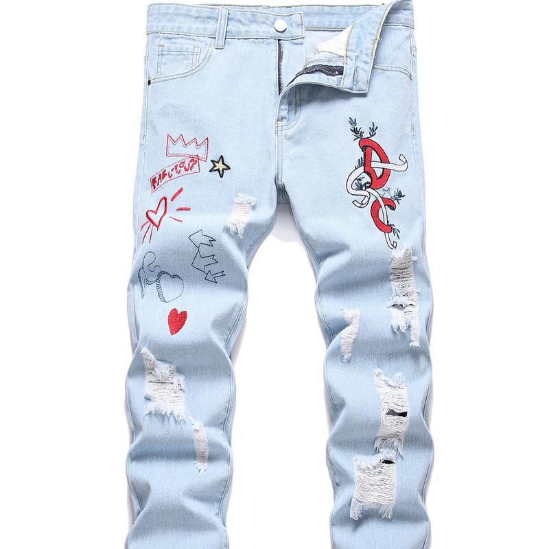 Close-up view of zipper detailing on men's distressed motorcycle jeans