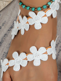 Flat Roman sandals with a flower design, offering comfort and style for summer outfits.








