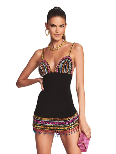Woman wearing a black sleeveless bodycon dress with colorful crystal embellishments, deep V-neckline, and thin straps—styled for a nightclub or evening party.


