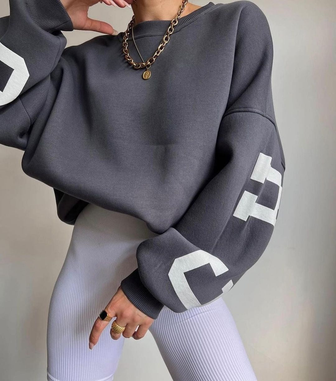 Woman wearing a printed thick long sleeve hoodie, looking cozy and stylish.

