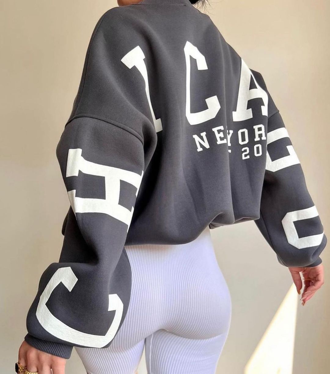 Woman wearing a printed thick long sleeve hoodie, looking cozy and stylish.

