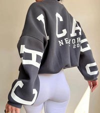 Woman wearing a printed thick long sleeve hoodie, looking cozy and stylish.


