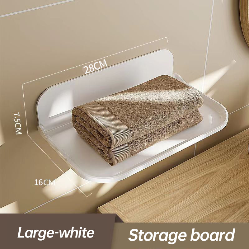 Wall-mounted plastic floating shelf in a modern bathroom holding towels