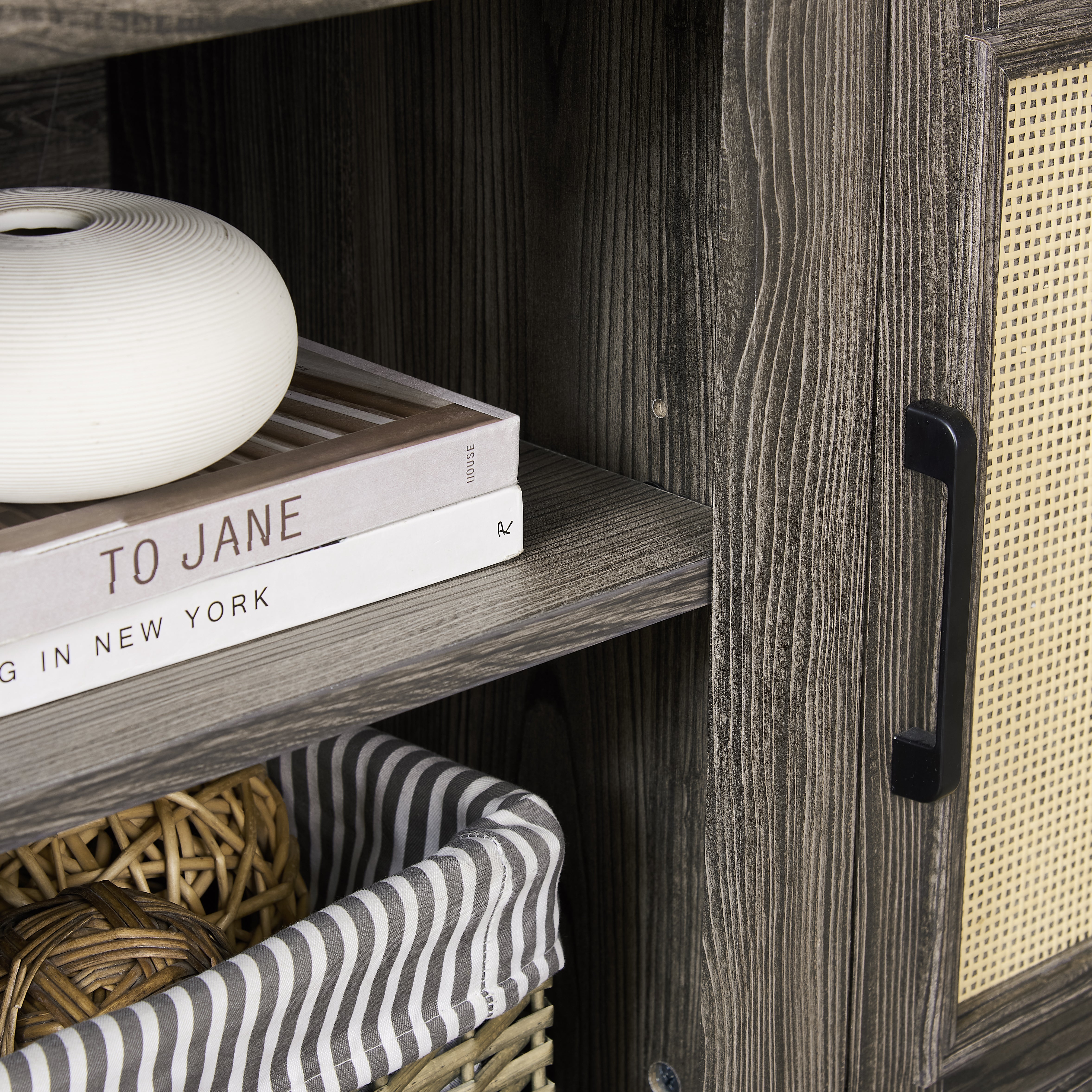Gray TV stand with rattan doors and shelves for storage