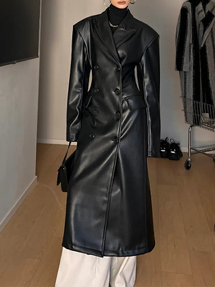 Model wearing a high-waist PU leather coat with patchwork detail and lapel collar