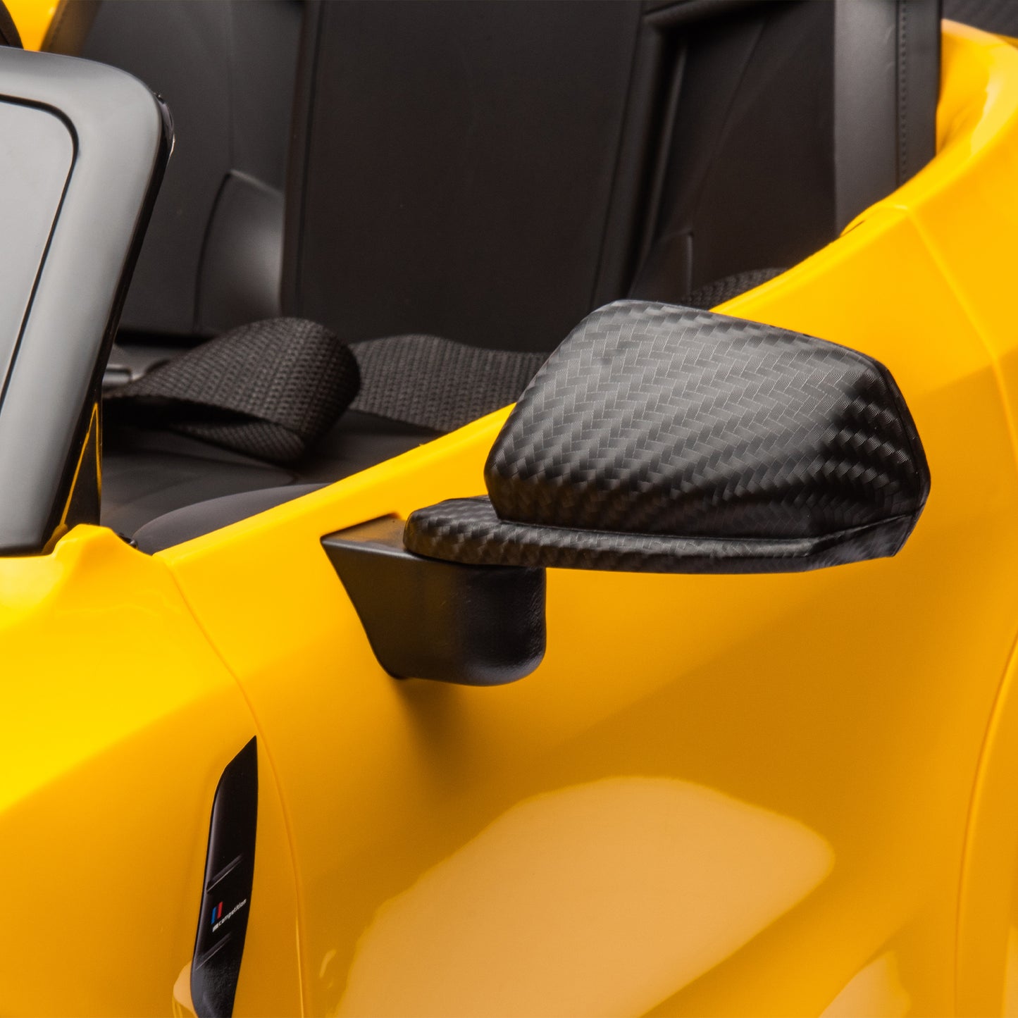 Yellow BMW M4 12V electric ride-on car for kids, featuring authentic design with working headlights, MP3 player, and forward/reverse motion. Comes with adjustable seat and steering wheel, providing a realistic driving experience for children aged 3-6