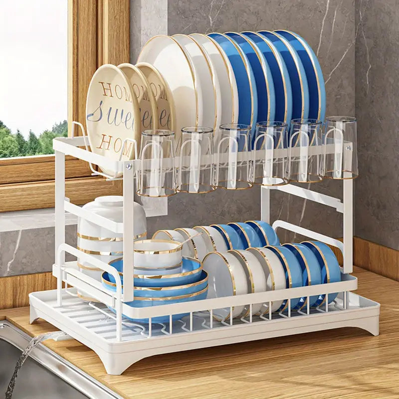 Kitchen drainage rack with bowls, plates, and utensils drying on a countertop

