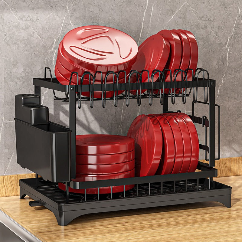 Kitchen drainage rack with bowls, plates, and utensils drying on a countertop

