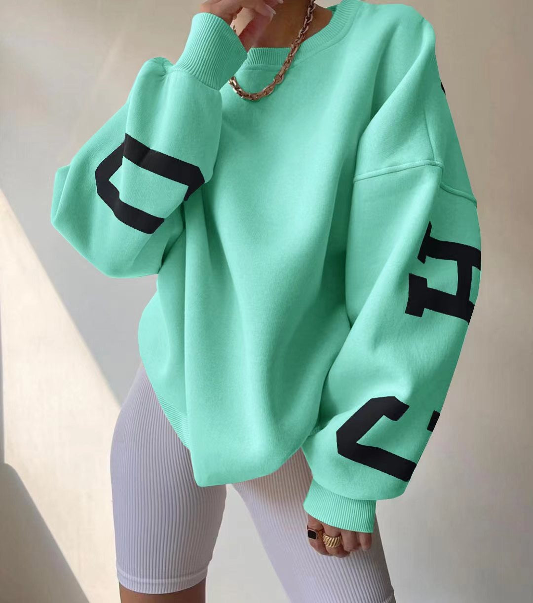 Woman wearing a printed thick long sleeve hoodie, looking cozy and stylish.

