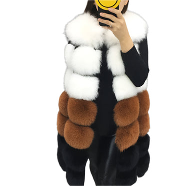 Woman wearing a colorful patchwork faux fur vest in winter setting