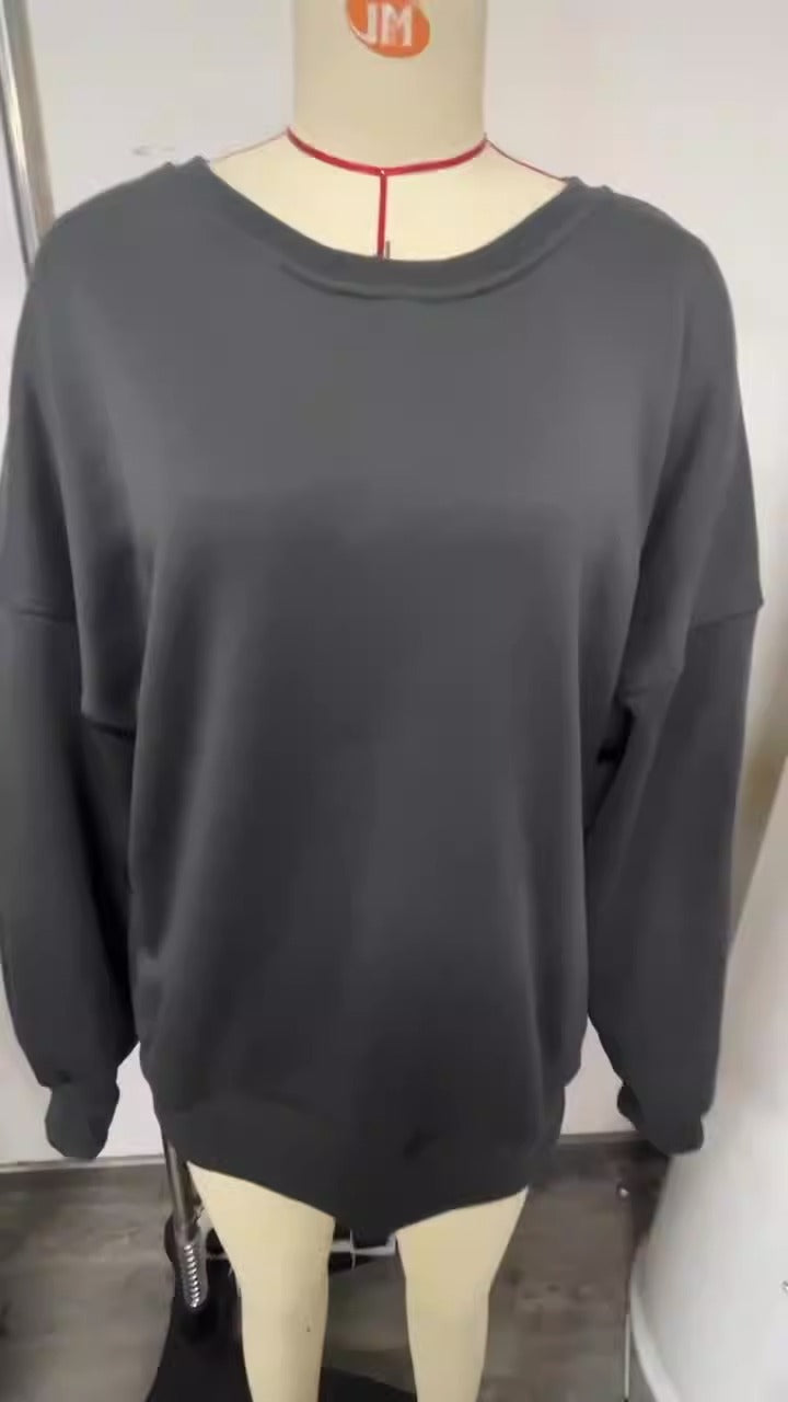 Woman wearing a printed thick long sleeve hoodie, looking cozy and stylish.


