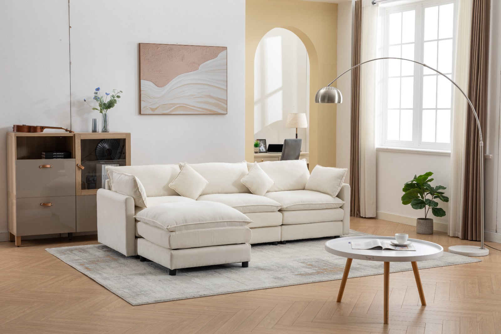 Modern L-shaped 3-seater modular sofa with ottoman in a living room setting.


