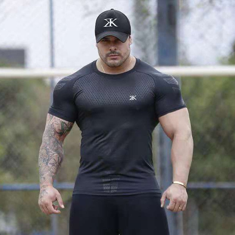 Man wearing a tight-fit short sleeve compression T-shirt in quick-dry fabric for running and sports training.

