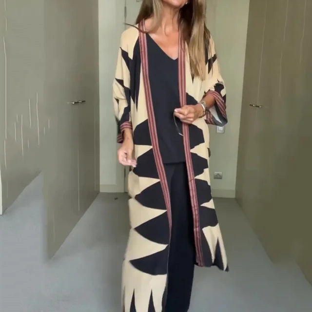 Model wearing printed long cardigan with jeans and boots

