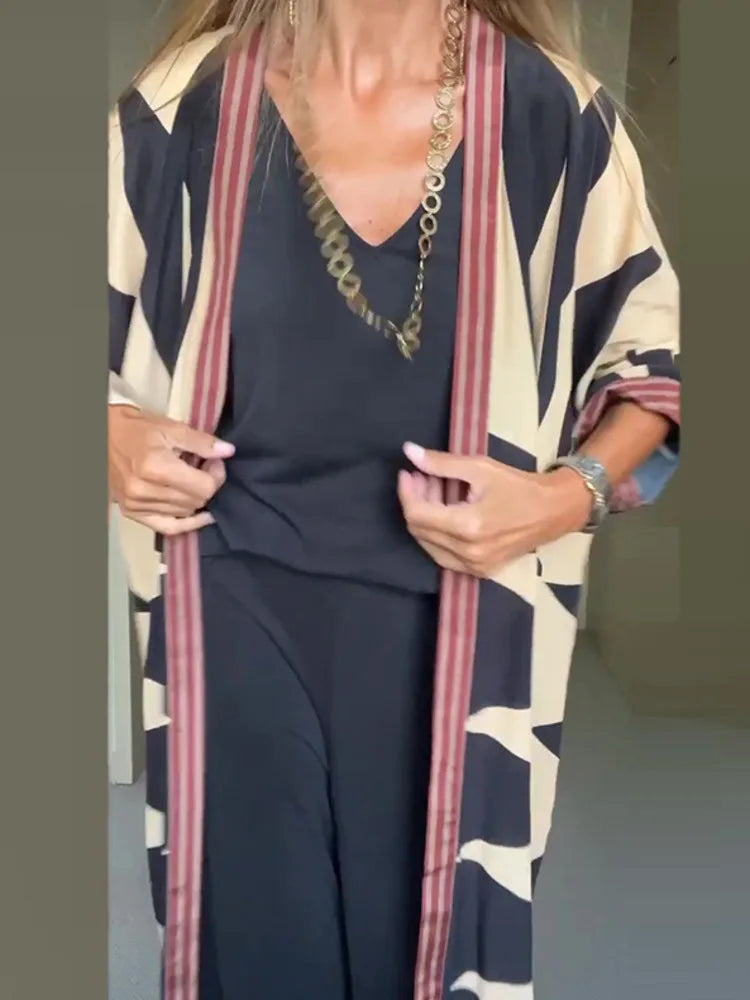 Model wearing printed long cardigan with jeans and boots

