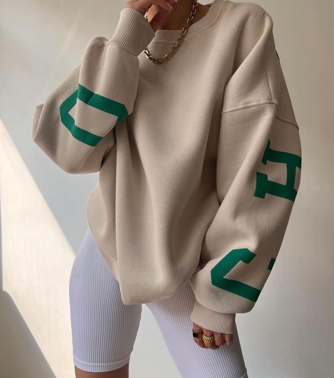 Woman wearing a printed thick long sleeve hoodie, looking cozy and stylish.

